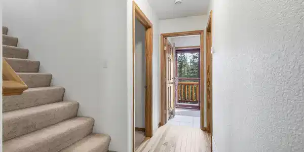 Image 4: Entry hall w/ Staircase leading up to the private primary suite Image 4: Entry hall w/ Staircase leading up to the private primary suite