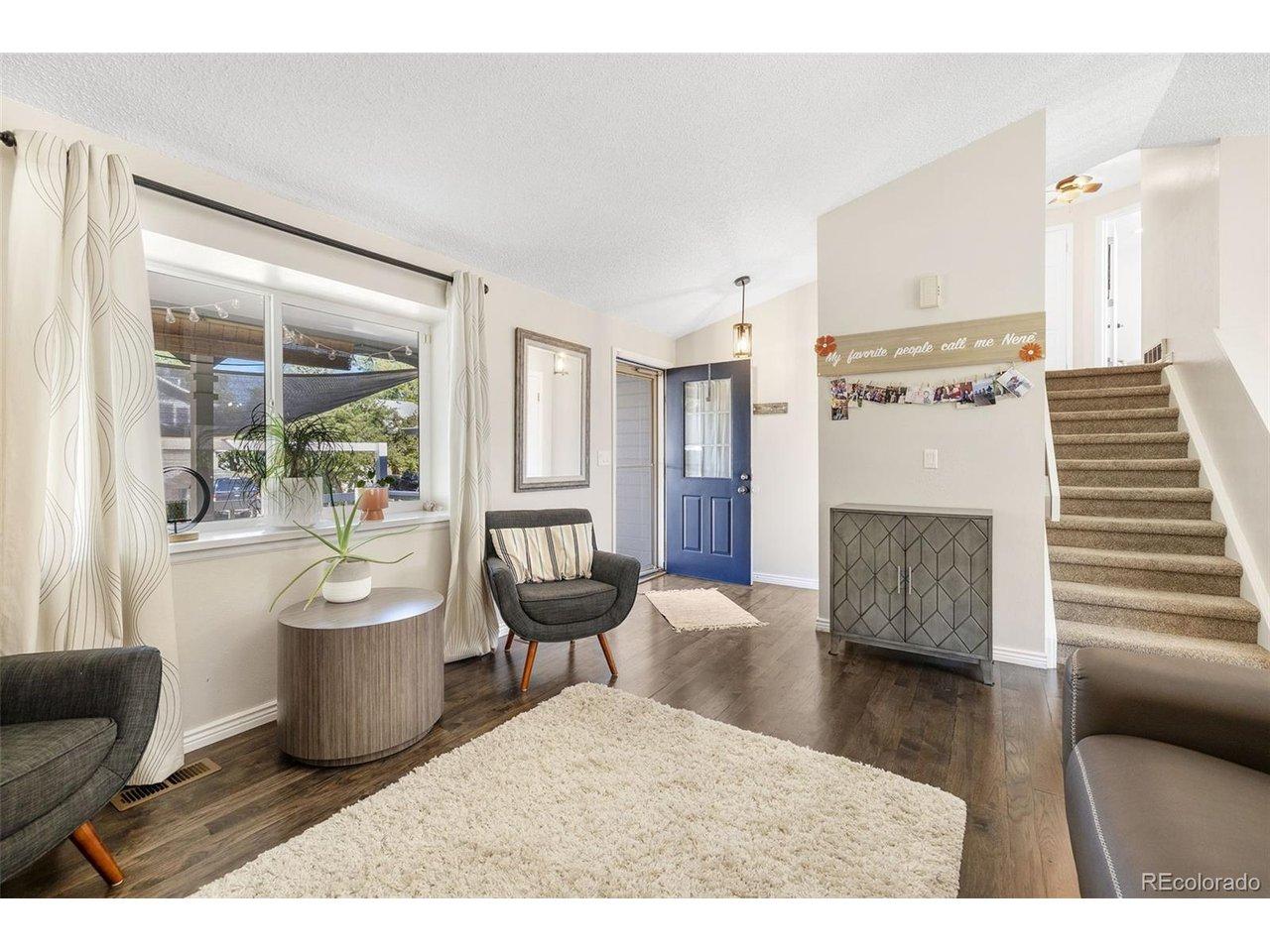 Image 4: Living room/entry way with vaulted ceilings, solid wood floors and large window Image 4: Living room/entry way with vaulted ceilings, solid wood floors and large window