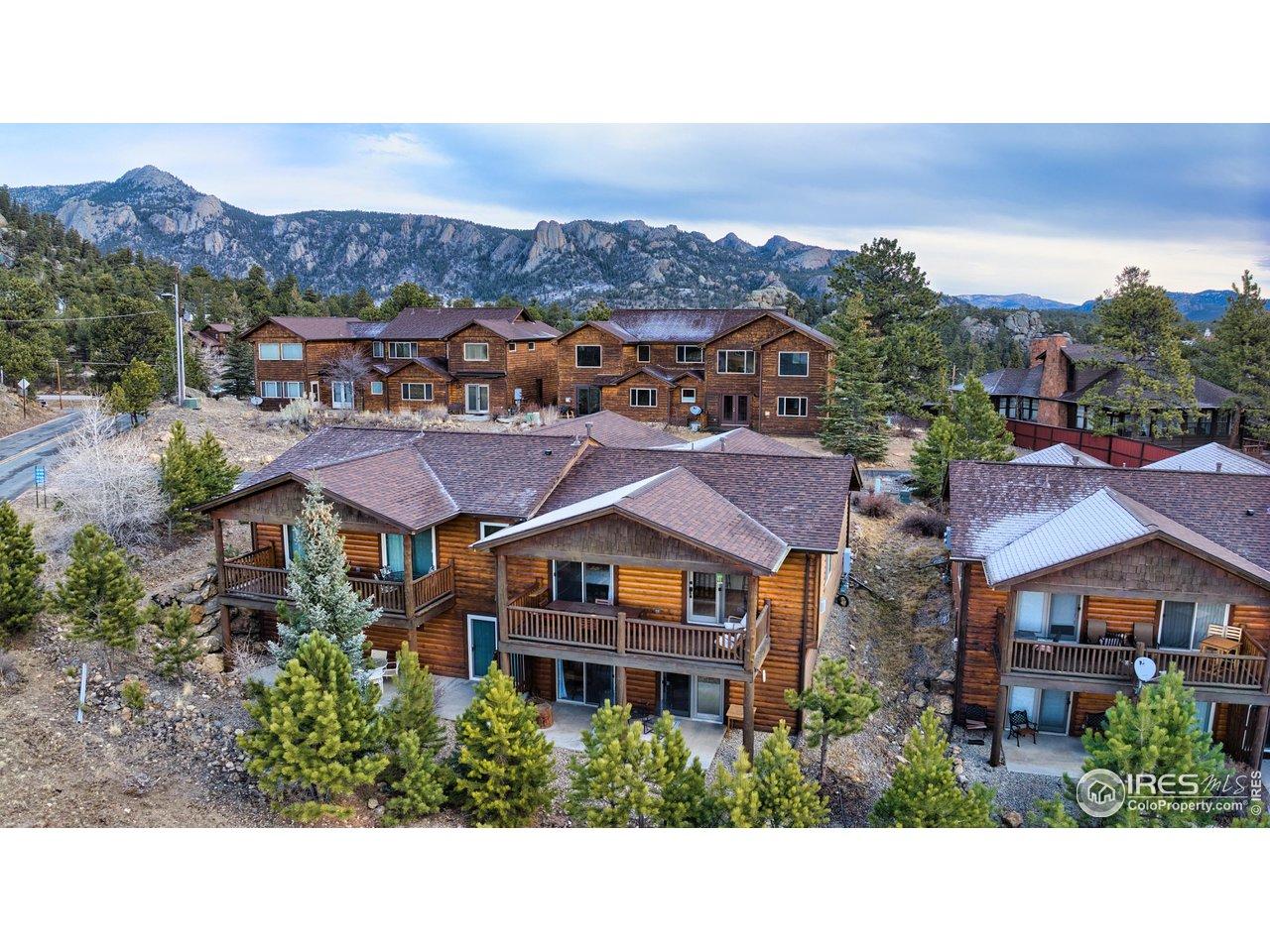 Image 2: Beautifully designed multi-level wooden townhome nestled against breathtaking mountain vistas. Featuring log siding, spacious decks, and mature landscaping with evergreen trees. Perfect mountain retreat with privacy and natural beauty. Image 2: Beautifully designed multi-level wooden townhome nestled against breathtaking mountain vistas. Featuring log siding, spacious decks, and mature landscaping with evergreen trees. Perfect mountain retreat with privacy and natural beauty.
