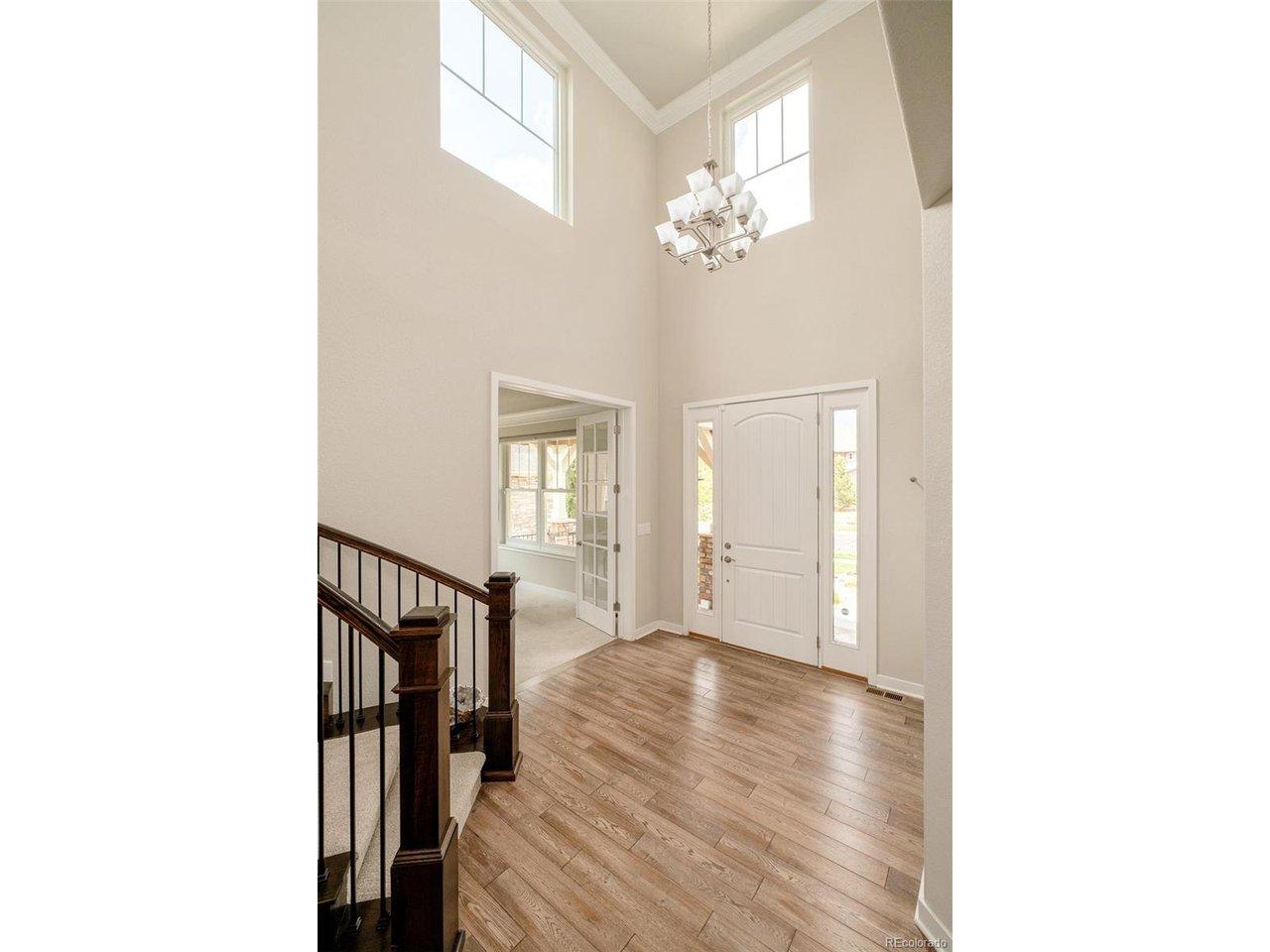 Image 4: Bright two-story foyer featuring oversized windows, designer lighting, and an open, airy feel. Image 4: Bright two-story foyer featuring oversized windows, designer lighting, and an open, airy feel.