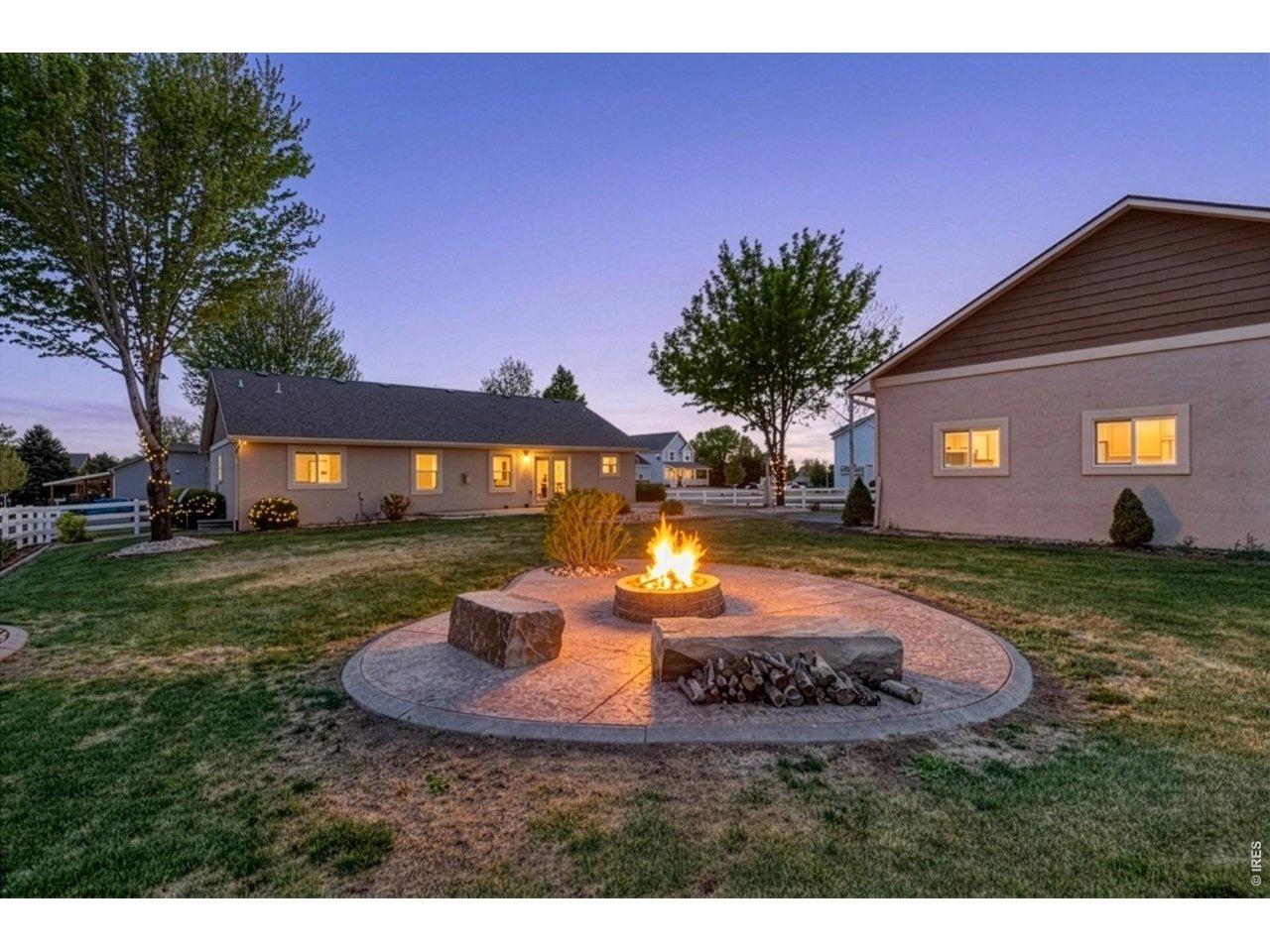 Image 2: The backyard is built for enjoying Colorado living with mature trees, a spacious 550 sq ft stamped patio, and a dedicated firepit area perfect for entertaining on summer evenings. Image 2: The backyard is built for enjoying Colorado living with mature trees, a spacious 550 sq ft stamped patio, and a dedicated firepit area perfect for entertaining on summer evenings.