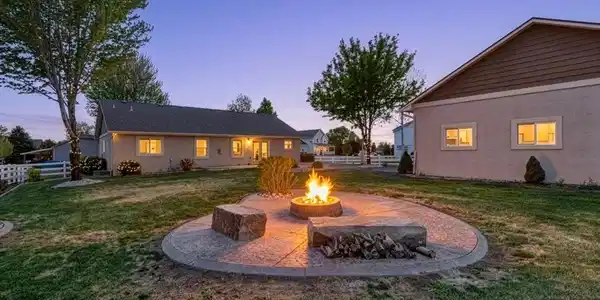 Image 2: The backyard is built for enjoying Colorado living with mature trees, a spacious 550 sq ft stamped patio, and a dedicated firepit area perfect for entertaining on summer evenings. Image 2: The backyard is built for enjoying Colorado living with mature trees, a spacious 550 sq ft stamped patio, and a dedicated firepit area perfect for entertaining on summer evenings.