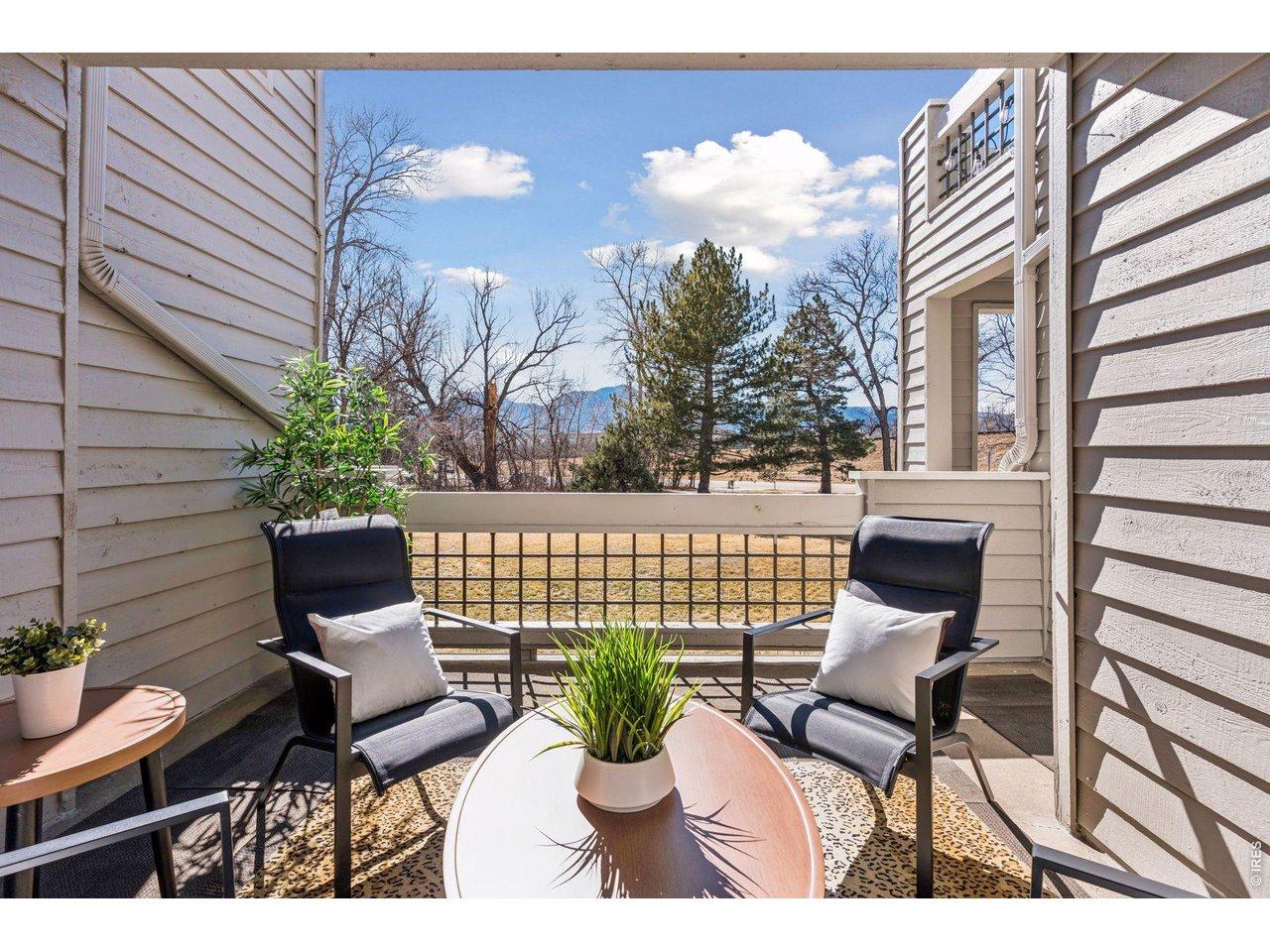 Image 2: Your private patio with an expansive green space and Mountain views will delight!