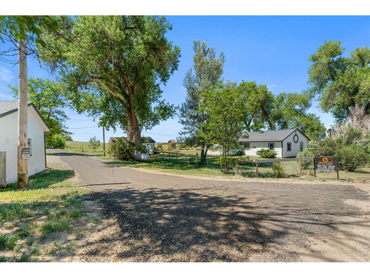 Image 1: Live the homestead dream ~ 2.3 acres w/ THREE OUTBUILDINGS and OPEN zoning. Lot lines are approximate & should be verified.