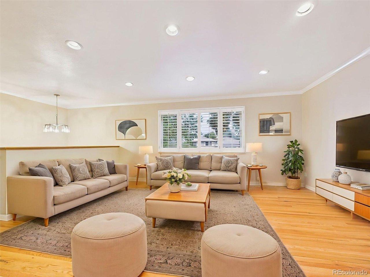 Image 4: (Virtually Staged) Living Room - Spacious living room filled with natural light, featuring beautifully refinished hardwood floors, recessed lighting, and plantation shutters for timeless style. Image 4: (Virtually Staged) Living Room - Spacious living room filled with natural light, featuring beautifully refinished hardwood floors, recessed lighting, and plantation shutters for timeless style.