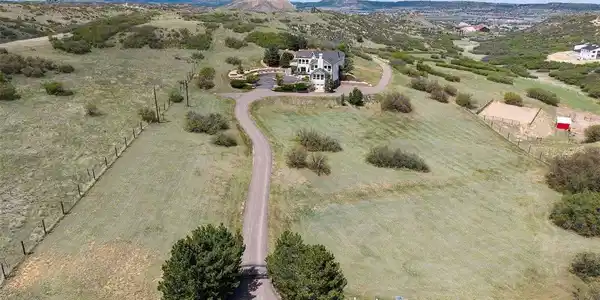 Image 2: A sweeping asphalt driveway with electric gate wraps around to the 4-car garage and winds down to the detached barn. Image 2: A sweeping asphalt driveway with electric gate wraps around to the 4-car garage and winds down to the detached barn.