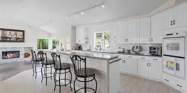 Image 4: The spacious kitchen features a huge island and is open to the great room with access to the large patio. Image 4: The spacious kitchen features a huge island and is open to the great room with access to the large patio.