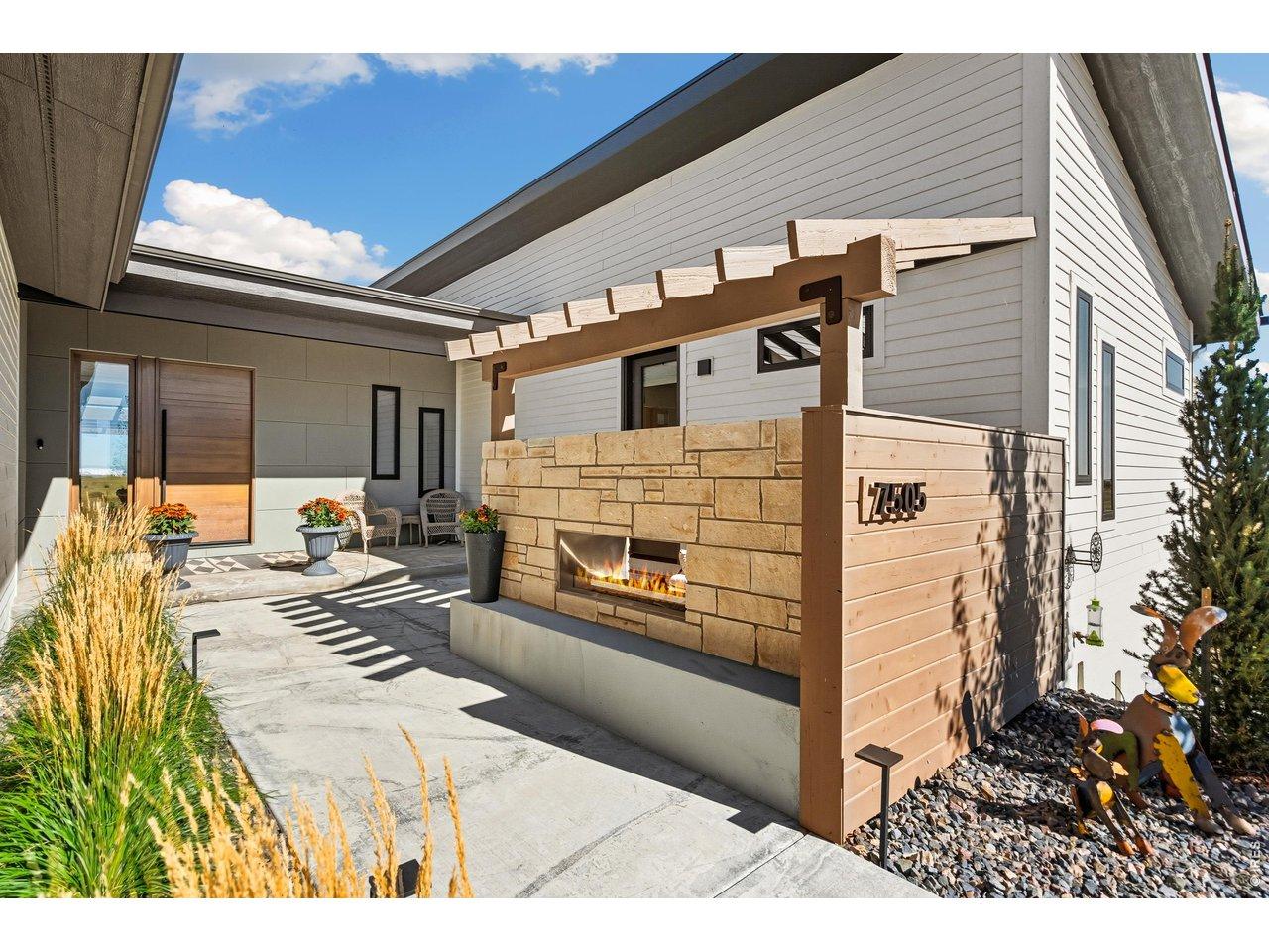 Image 3: Entry is next level with this built in fireplace and quiet courtyard area Image 3: Entry is next level with this built in fireplace and quiet courtyard area