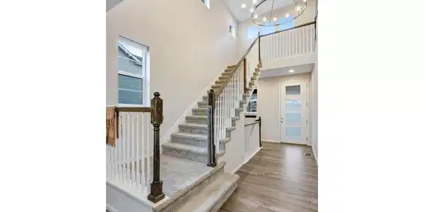 Image 3: Grand entry with vaulted ceilings and chandelier