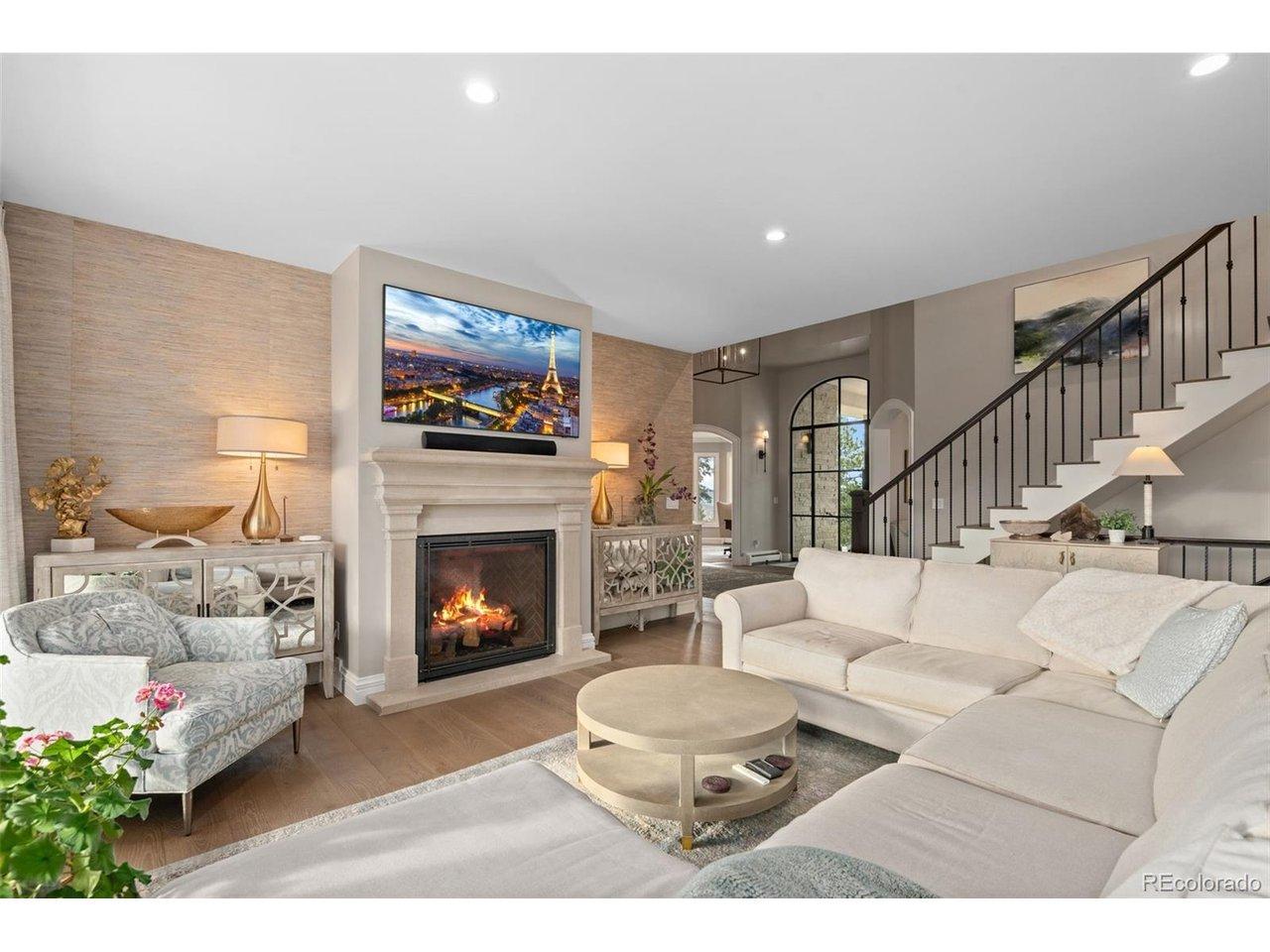 Image 4: The central living area with cast arched fireplace, hardwood look floors and views for miles Image 4: The central living area with cast arched fireplace, hardwood look floors and views for miles