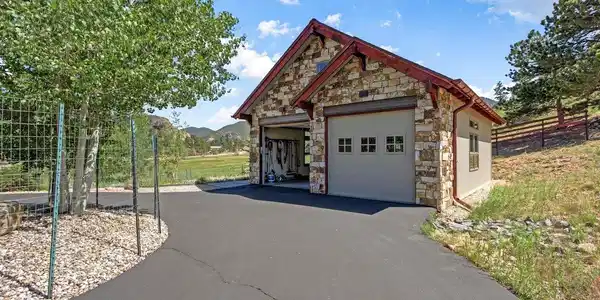 Image 3: The detached garage built in 2020 by Kinley Built combines elegance with exceptional functionality for vehicles, recreation, and storage. Both the attached and detached garages have Epoxy-coated floors. Image 3: The detached garage built in 2020 by Kinley Built combines elegance with exceptional functionality for vehicles, recreation, and storage. Both the attached and detached garages have Epoxy-coated floors.