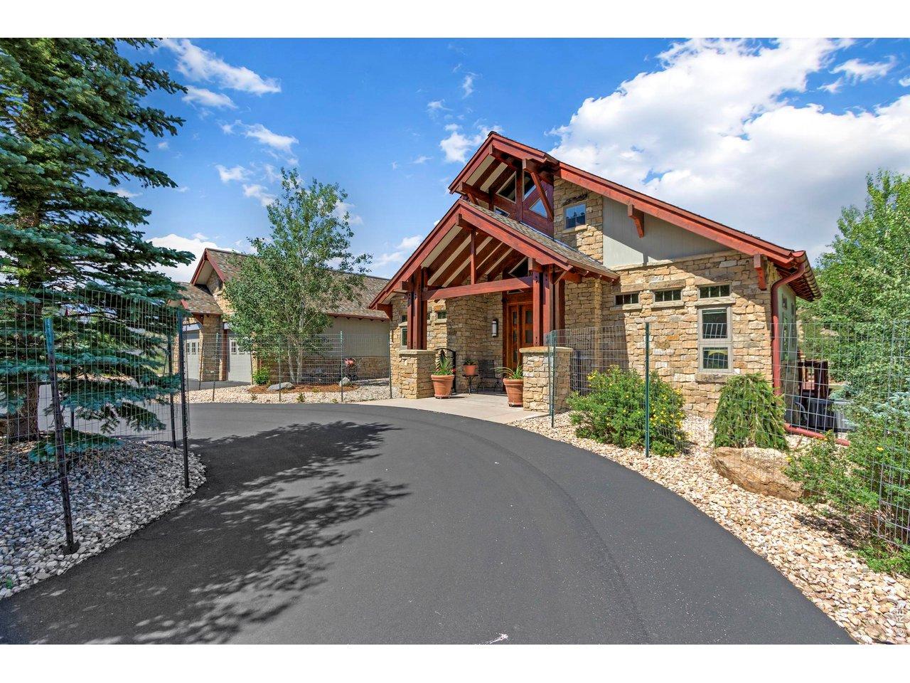 Image 4: Rich natural stone, exposed timber beams, and custom craftsmanship define this warm and welcoming mountain-inspired entrance. Image 4: Rich natural stone, exposed timber beams, and custom craftsmanship define this warm and welcoming mountain-inspired entrance.