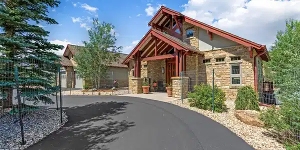 Image 4: Rich natural stone, exposed timber beams, and custom craftsmanship define this warm and welcoming mountain-inspired entrance. Image 4: Rich natural stone, exposed timber beams, and custom craftsmanship define this warm and welcoming mountain-inspired entrance.