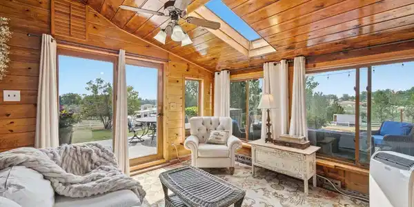 Image 4: The sunroom is a bright and sunny spot to relax and take in the view Image 4: The sunroom is a bright and sunny spot to relax and take in the view