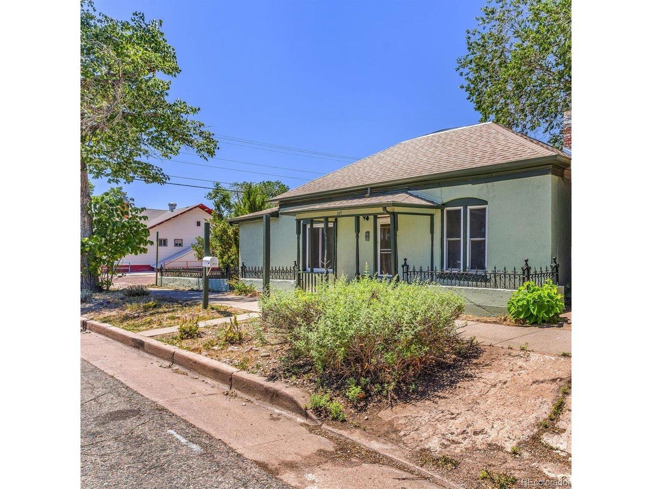 Image 4: Stucco exterior with a covered front porch featuring decorative columns