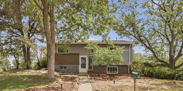 Image 3: Set back from the street and framed by mature trees, 804 S. Queen Way sits on a 10,411 sq ft corner lot in Lakewood with easy access to 6th Ave, Main Reservoir, and Green Mountain trails. Image 3: Set back from the street and framed by mature trees, 804 S. Queen Way sits on a 10,411 sq ft corner lot in Lakewood with easy access to 6th Ave, Main Reservoir, and Green Mountain trails.