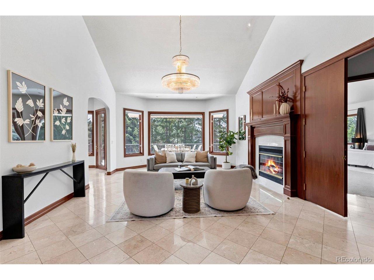Image 4: Inviting living room with marble tiles, fireplace and Italian chandelier Image 4: Inviting living room with marble tiles, fireplace and Italian chandelier