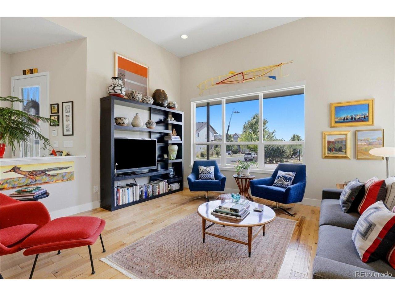 Image 4: Soaring ceilings, hardwood floors and oversized windows bring a bright, airy quality to the main living room. Image 4: Soaring ceilings, hardwood floors and oversized windows bring a bright, airy quality to the main living room.