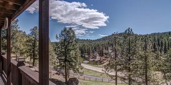 Image 2: Front Deck View of neighboring pond and mountain view