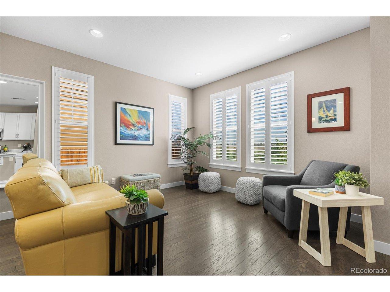 Image 4: Sun-filled main living area showcasing oversized windows, engineered wood flooring, and an open-concept layout - natural light pours into this 3 bed, 2.5 bath Broomfield townhome backing to permanent open space. Image 4: Sun-filled main living area showcasing oversized windows, engineered wood flooring, and an open-concept layout - natural light pours into this 3 bed, 2.5 bath Broomfield townhome backing to permanent open space.