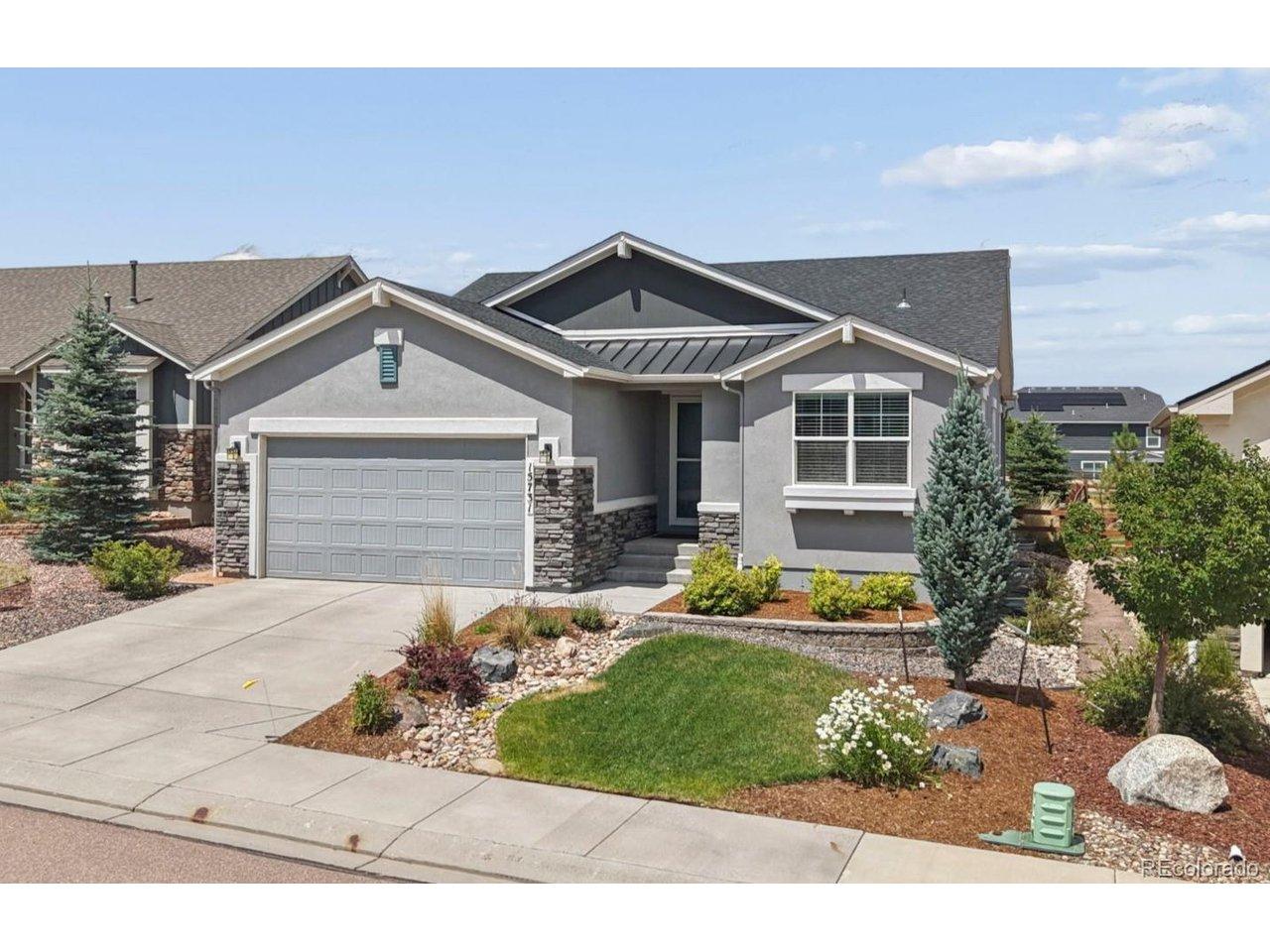 Image 1: Stucco and stone exterior featuring a 3 car tandem garage, dark shingle roof, and a front entry porch with storm door Image 1: Stucco and stone exterior featuring a 3 car tandem garage, dark shingle roof, and a front entry porch with storm door