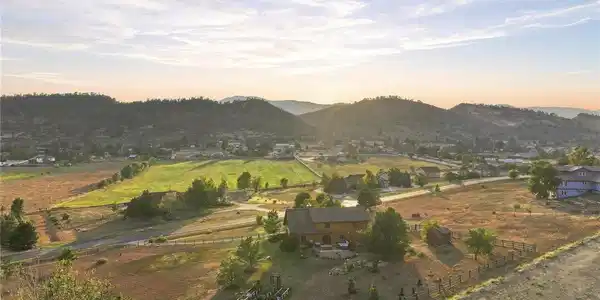 Image 2: Nestled in a valley with stunning, sweeping mountain and lush valley views Image 2: Nestled in a valley with stunning, sweeping mountain and lush valley views