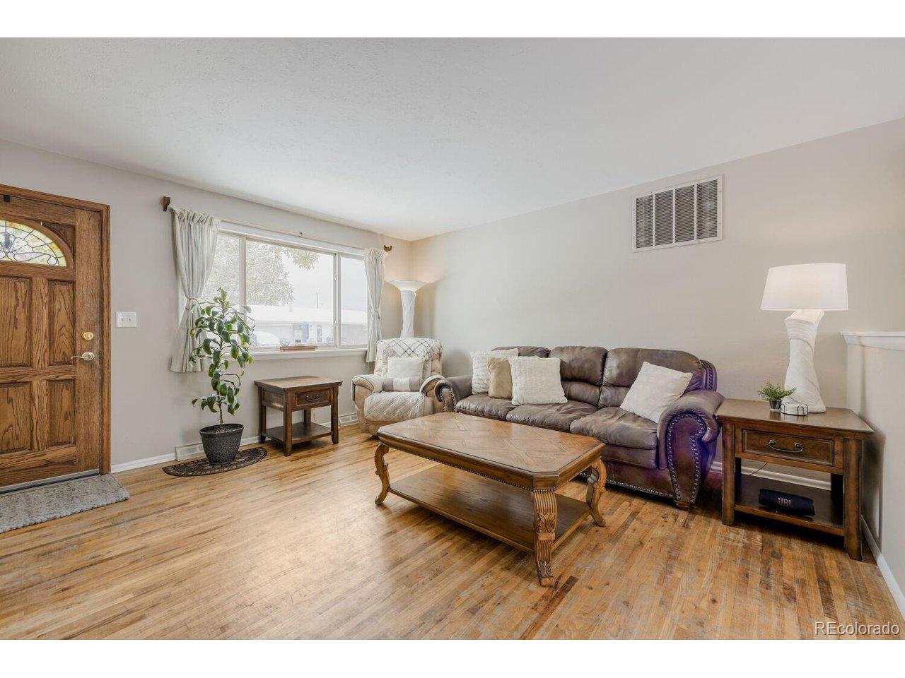 Image 3: Living Room with Hardwood Floors
