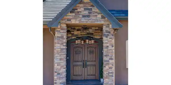 Image 3: Mahogany door w/ speakeasy door & wrought iron grill and large, rustic chandelier Image 3: Mahogany door w/ speakeasy door & wrought iron grill and large, rustic chandelier