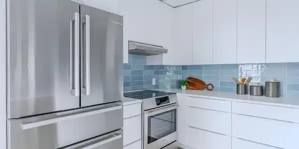 Image 4: Stainless Bosch appliances, complemented by an induction range with an exterior vent hood for a clean cooking experience, lend both performance and polish, and a soft tile backsplash introduces a gentle layer of texture. Image 4: Stainless Bosch appliances, complemented by an induction range with an exterior vent hood for a clean cooking experience, lend both performance and polish, and a soft tile backsplash introduces a gentle layer of texture.