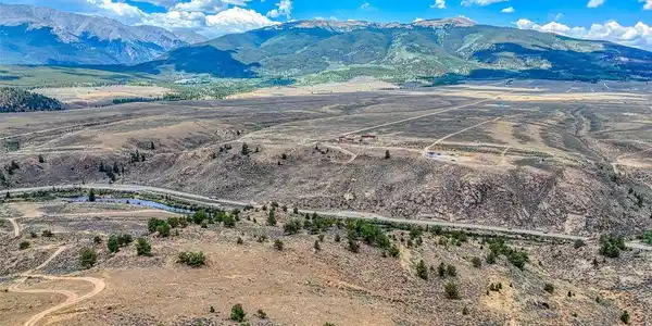 Image 4: Arkansas River and Highway 24 below with Sawatch Mtn Range in background, Jeep trail coming up to top of property visible to left