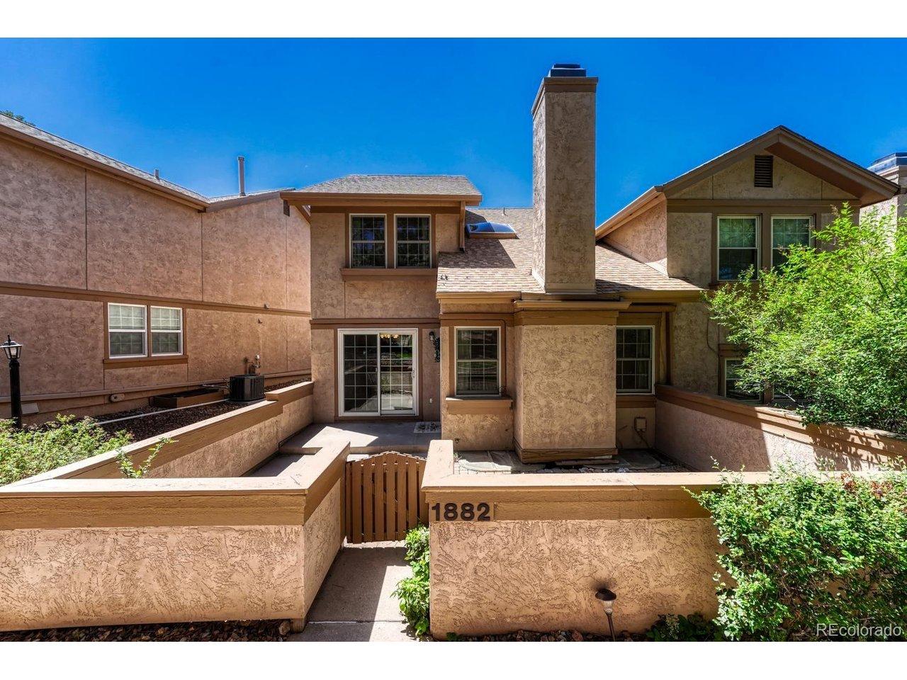 Image 2: Enclosed courtyard with a concrete and paver patio for outdoor relaxation and fun.