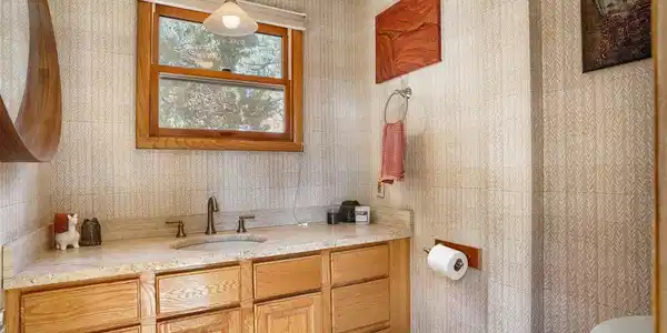 Image 3: Stunning powder room with high-end finishes and bright, natural lighting. Image 3: Stunning powder room with high-end finishes and bright, natural lighting.