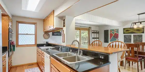Image 4: This spacious, modern kitchen is filled with natural light and features an expansive layout, complete with extensive counter space Image 4: This spacious, modern kitchen is filled with natural light and features an expansive layout, complete with extensive counter space