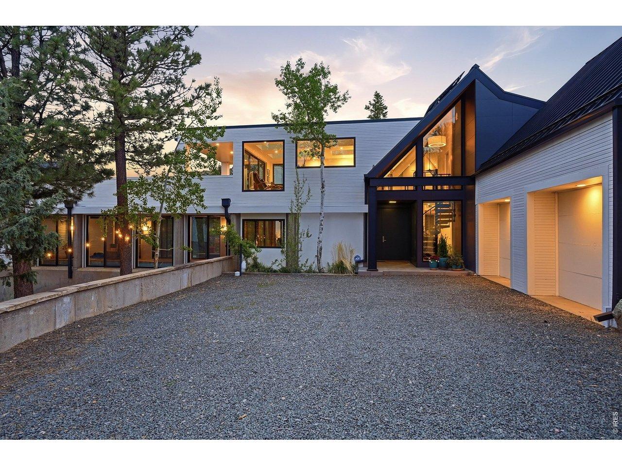 Image 4: Front entry has large courtyard, with attached 2 car garage and detached 2 car carport. All exterior siding is Class A fire rated material.