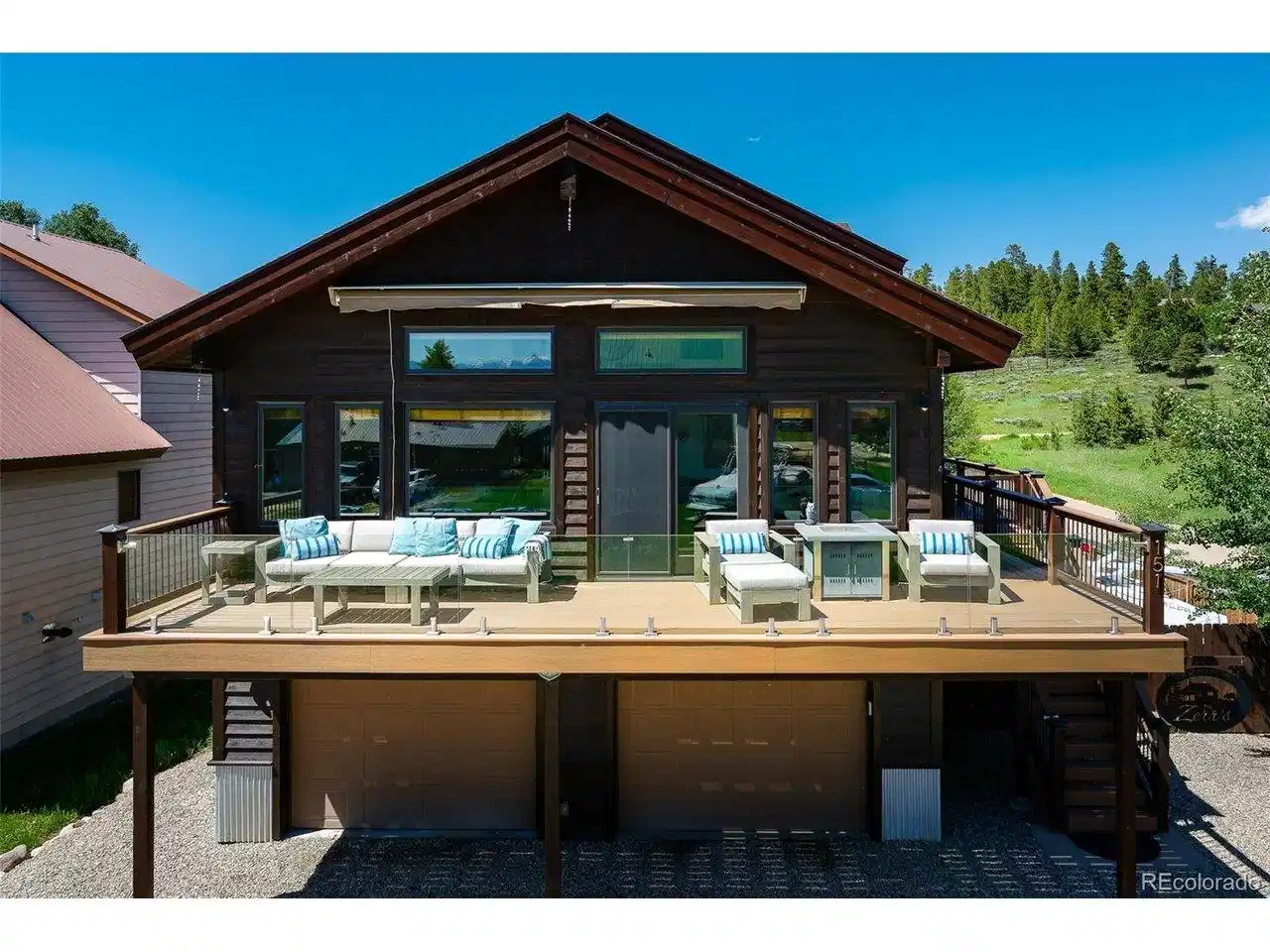 Image 1: front of home featuring large wrap around deck Image 1: front of home featuring large wrap around deck