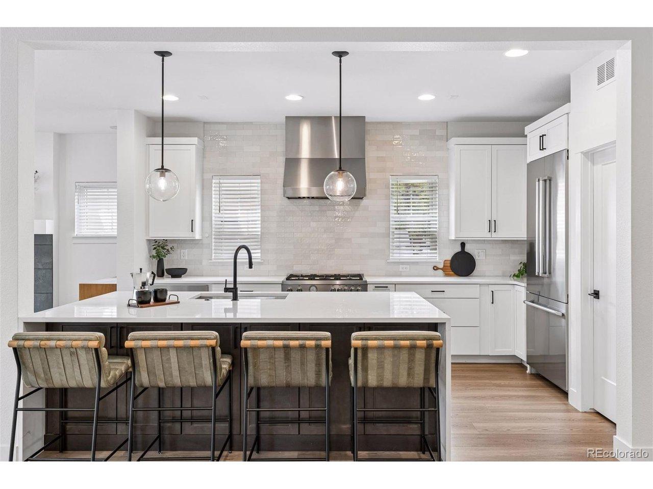 Image 4: Crisp, white cabinetry with subtle detailing forms the backdrop and polished counters amplify the luminosity, creating an ethereal glow that permeates the entire home. Image 4: Crisp, white cabinetry with subtle detailing forms the backdrop and polished counters amplify the luminosity, creating an ethereal glow that permeates the entire home.