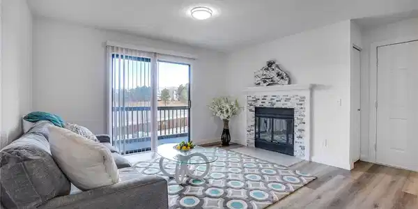 Image 2: Light and bright living area with wood burning fireplace