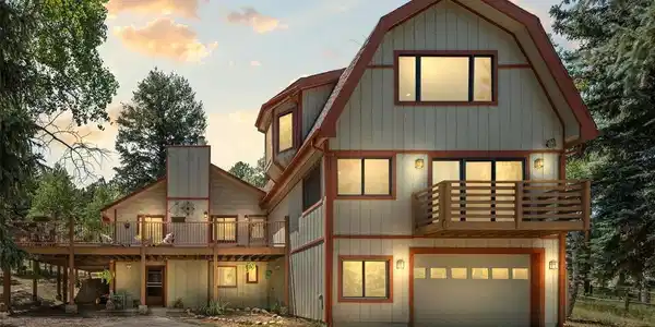Image 2: Welcoming exterior surrounded by mature pines and aspens