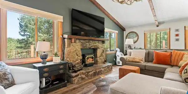 Image 3: Inviting great room with dramatic stone fireplace and abundant natural light