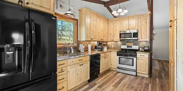 Image 4: Well-appointed kitchen with generous cabinetry and workspace