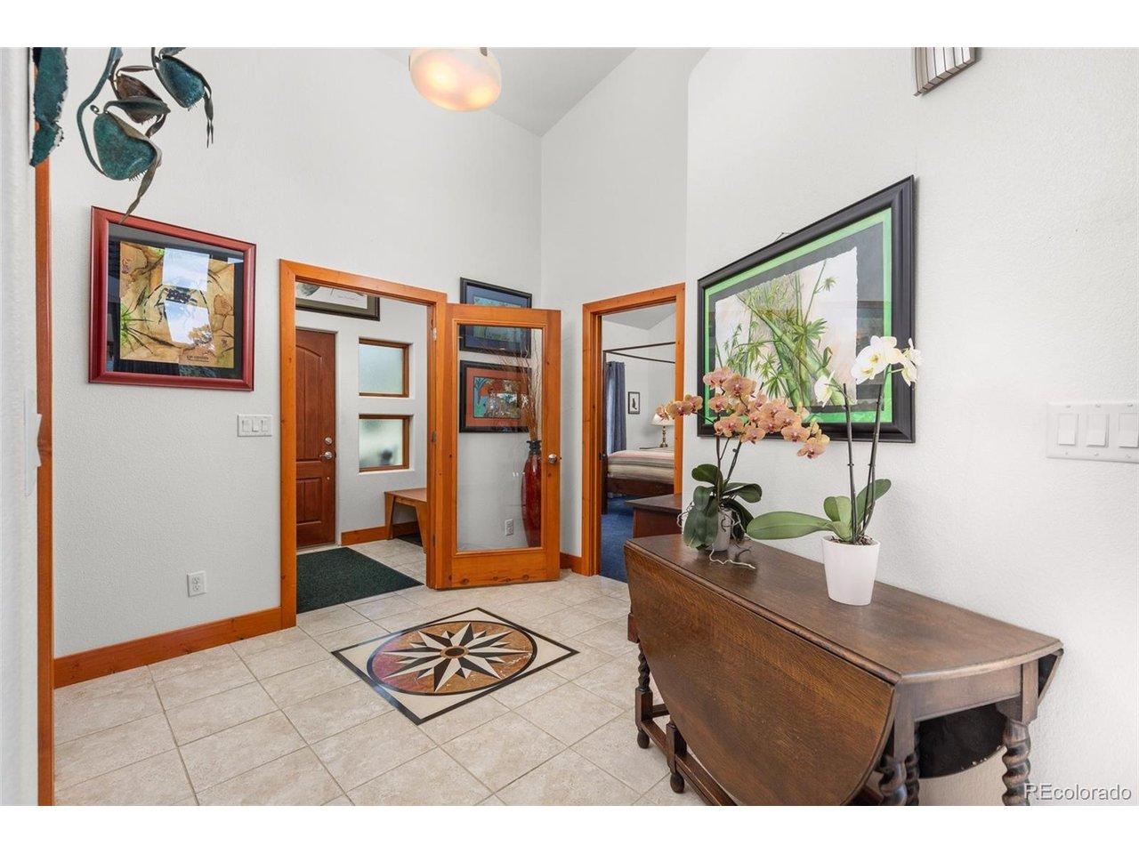 Image 4: Airlock entry into home with custom tile inlay. Image 4: Airlock entry into home with custom tile inlay.