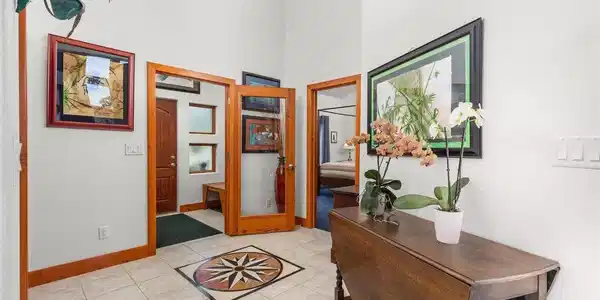 Image 4: Airlock entry into home with custom tile inlay. Image 4: Airlock entry into home with custom tile inlay.