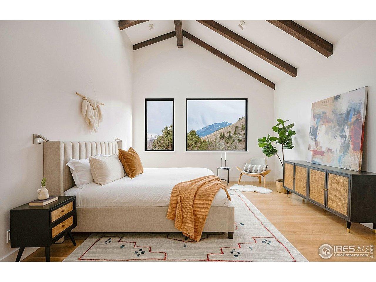 Image 1: Primary bedroom suite with unobstructed views of Boulder's iconic Flatirons Image 1: Primary bedroom suite with unobstructed views of Boulder's iconic Flatirons