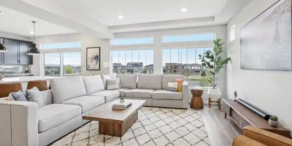 Image 4: Open concept kitchen to living room for ultimate relaxation. Wall of windows provides wonderful mountain views.
