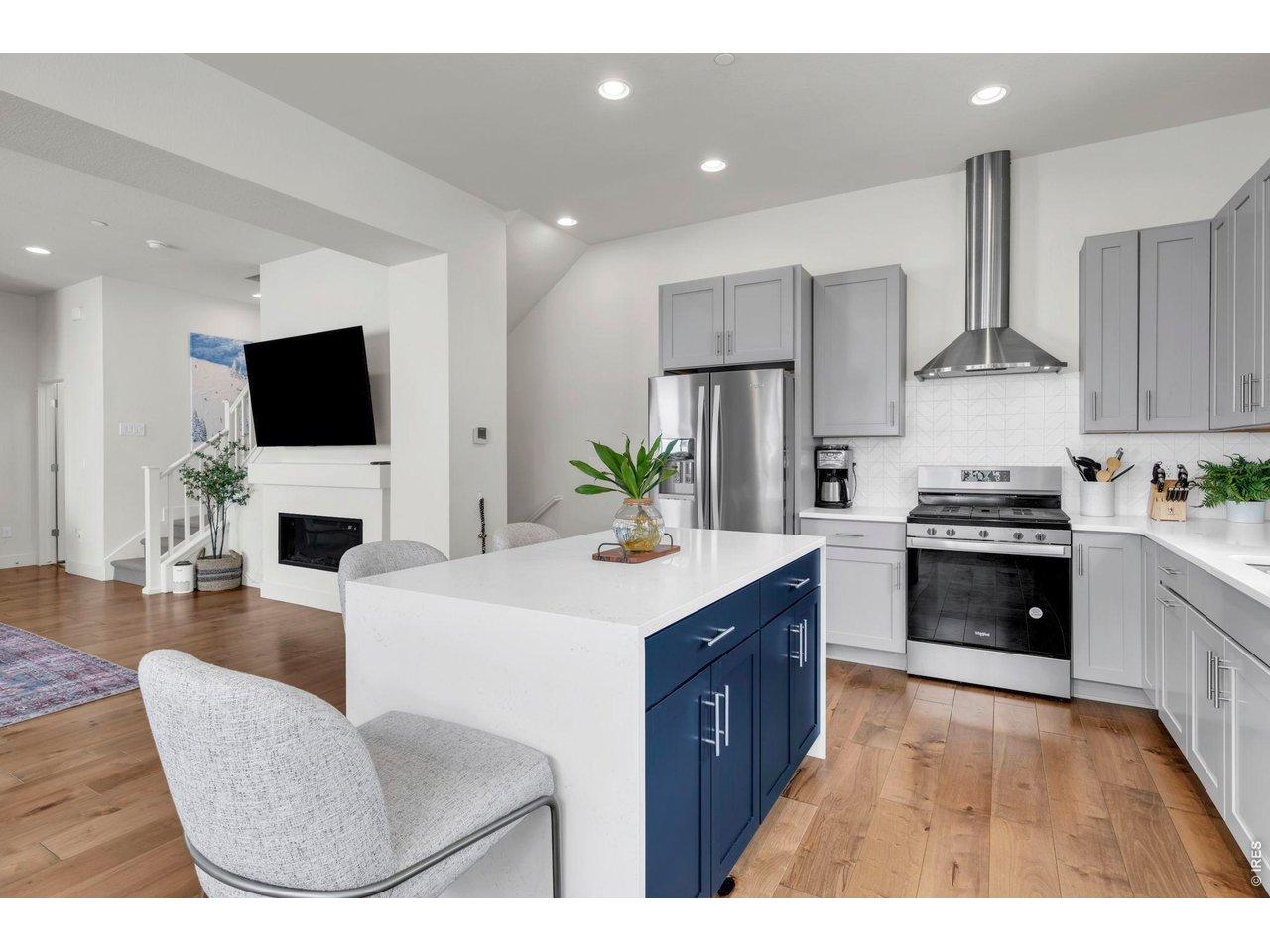 Image 3: The stunning chef's kitchen features sleek quartz countertops, soft gray cabinetry, stainless Whirlpool appliances Image 3: The stunning chef's kitchen features sleek quartz countertops, soft gray cabinetry, stainless Whirlpool appliances