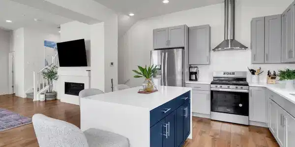 Image 3: The stunning chef's kitchen features sleek quartz countertops, soft gray cabinetry, stainless Whirlpool appliances Image 3: The stunning chef's kitchen features sleek quartz countertops, soft gray cabinetry, stainless Whirlpool appliances