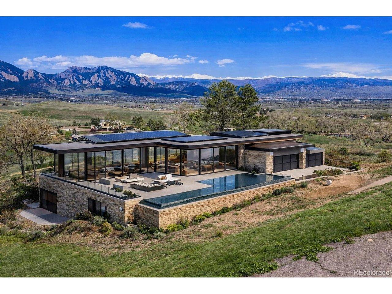 Image 2: Architectural rendering illustrating one possible vision for this exceptional homesite. This contemporary glass pavilion design emphasizes seamless indoor-outdoor living and unobstructed Flatirons views. Images are architectural renderings for illustrative Image 2: Architectural rendering illustrating one possible vision for this exceptional homesite. This contemporary glass pavilion design emphasizes seamless indoor-outdoor living and unobstructed Flatirons views. Images are architectural renderings for illustrative