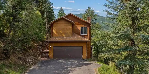 Image 2: Front exterior and wooded setting Image 2: Front exterior and wooded setting