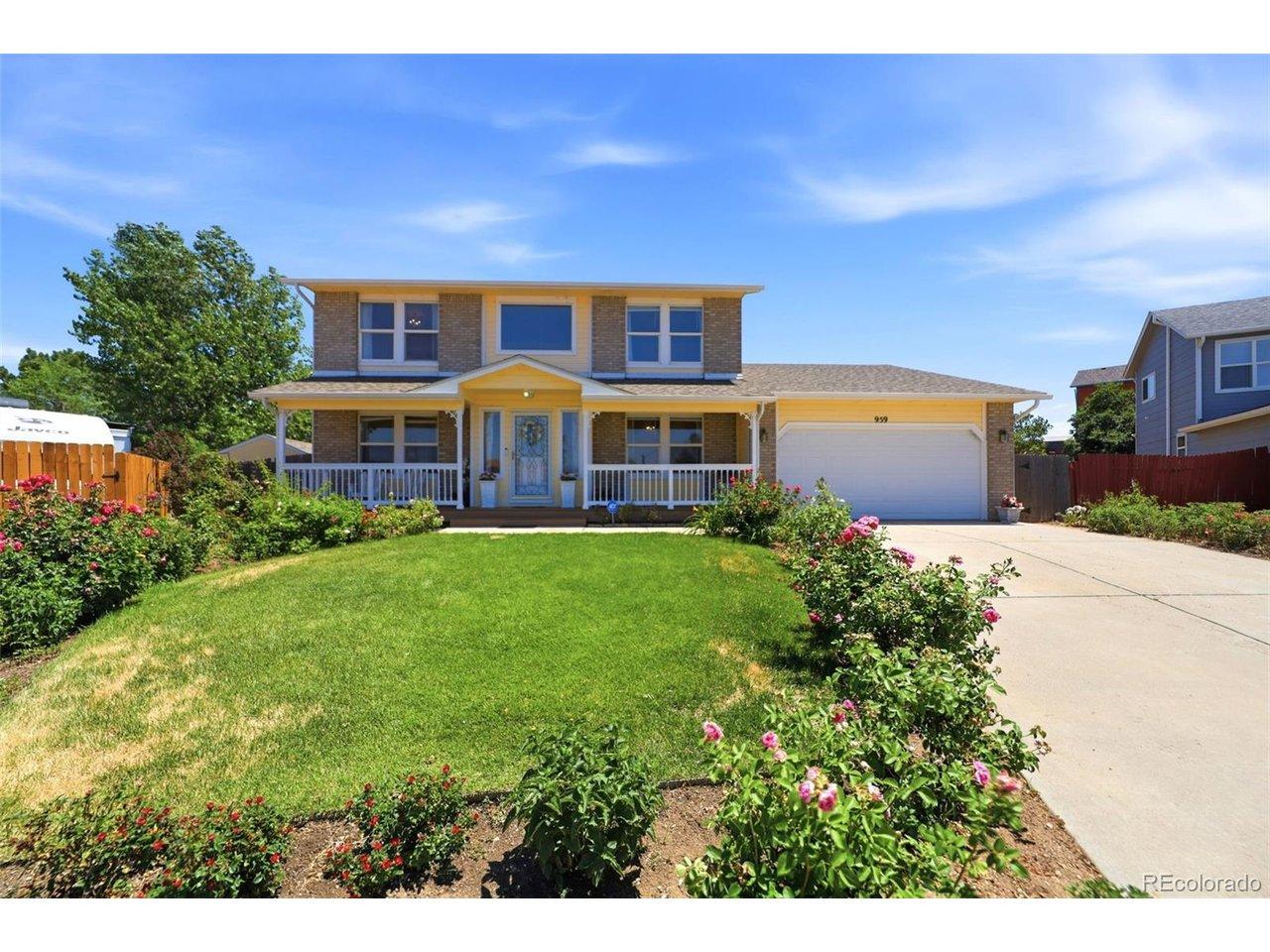 Image 2: wo-story residence featuring a covered front porch with white railings, a two-car garage, and a concrete driveway Image 2: wo-story residence featuring a covered front porch with white railings, a two-car garage, and a concrete driveway