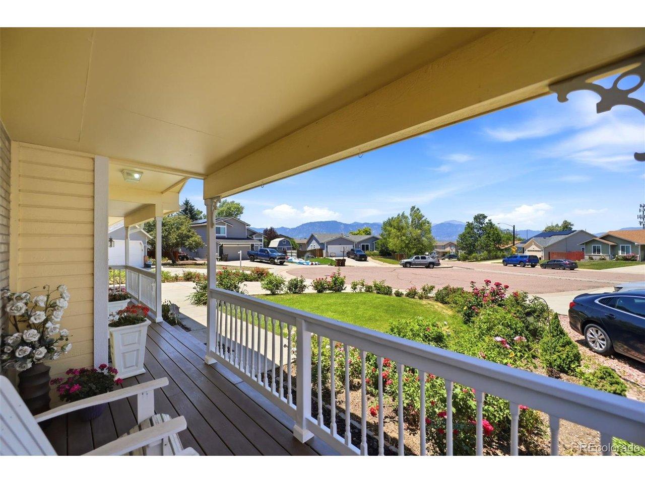 Image 3: Covered front porch with composite wood-finish flooring, white railing, and exterior lighting Image 3: Covered front porch with composite wood-finish flooring, white railing, and exterior lighting